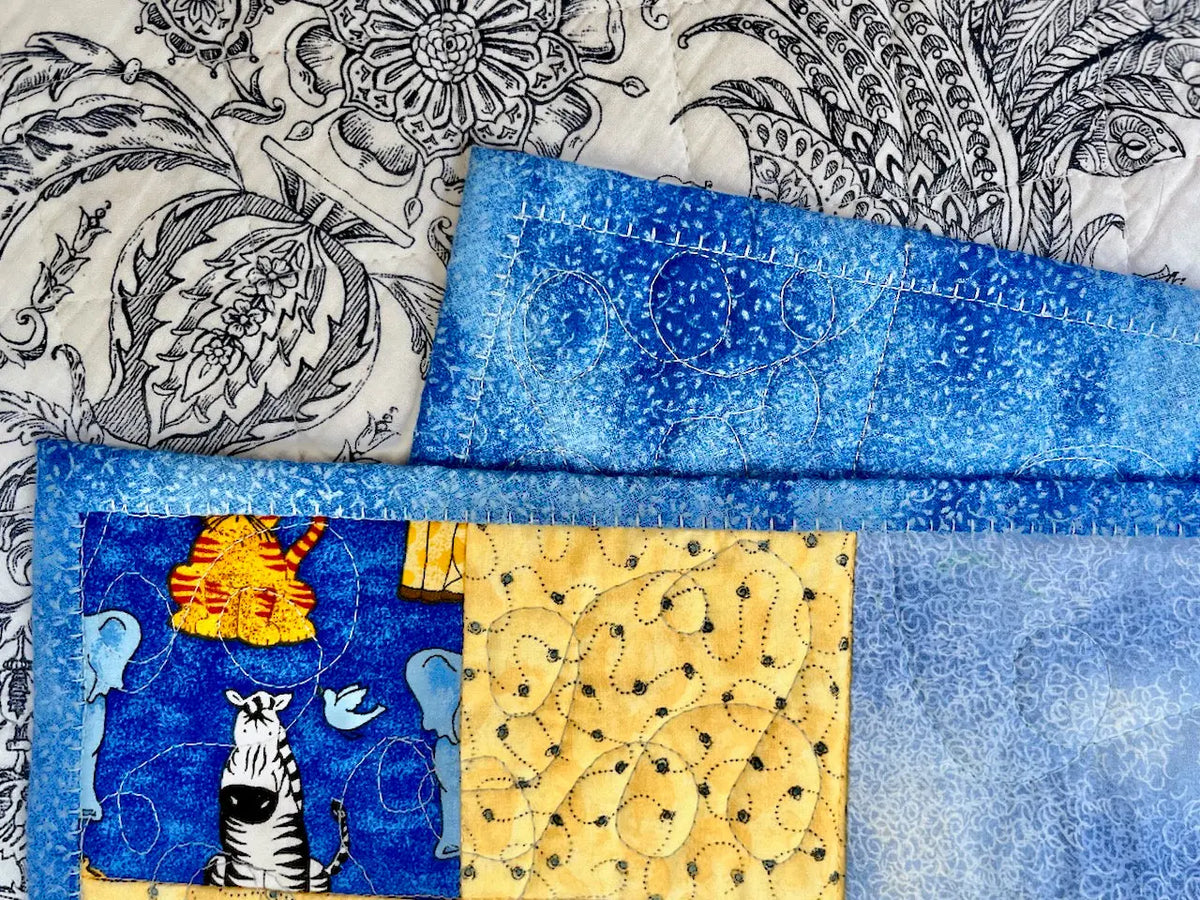close up of baby quilt blanket stitch