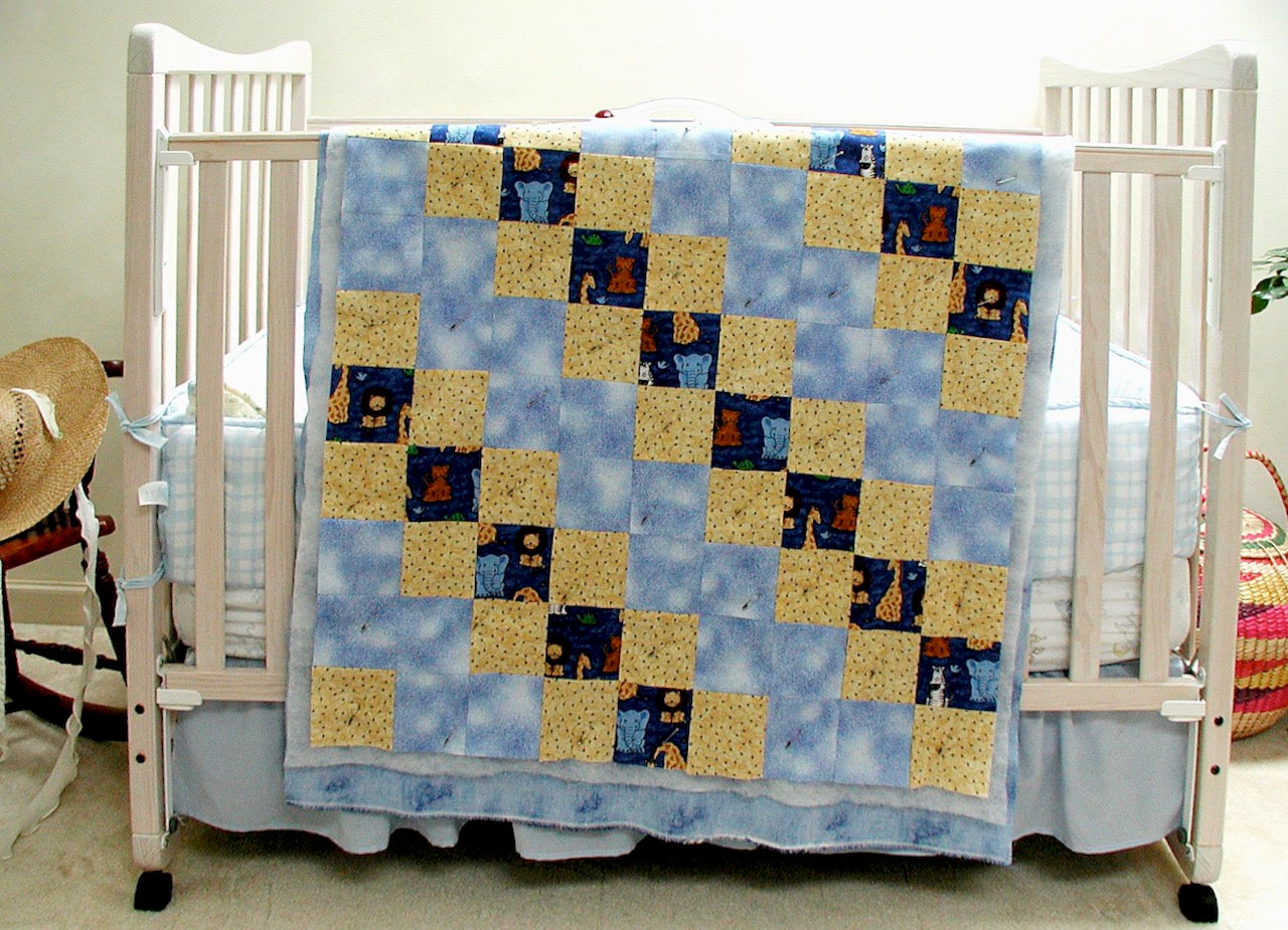 baby quilt draped over a crib
