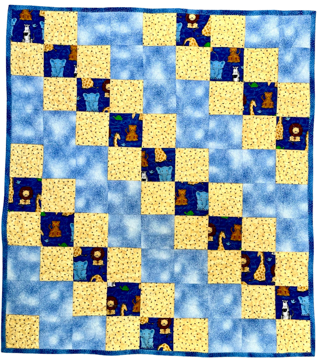 Patchwork quilt with blue and yellow squares featuring animal illustrations