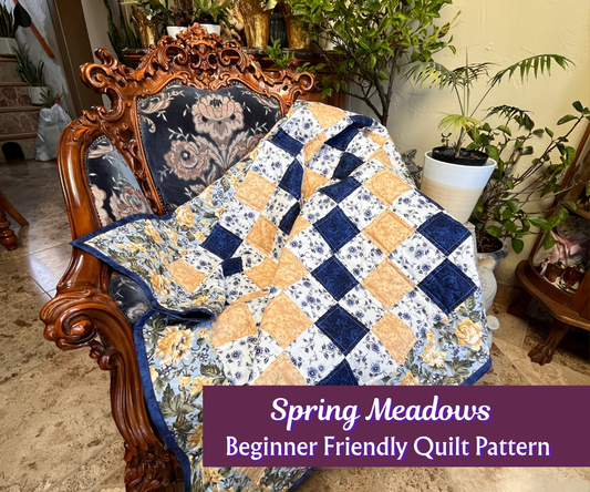 Quilt with blue and yellow diamond pattern draped over a wooden chair in a home setting.