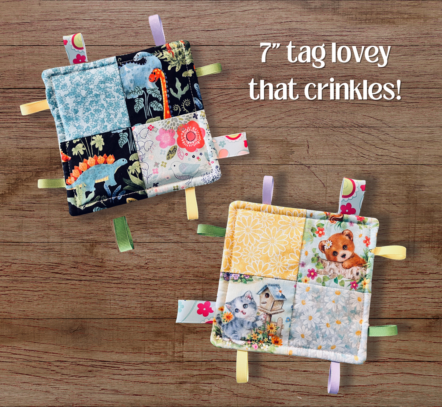 Two handmade patchwork fabric lovey tags with colorful ribbon tags, displayed on a wooden background. One has dinosaur and floral prints, and the other has cat and bear prints. They crinkle!