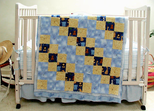 baby quilt draped over a crib 