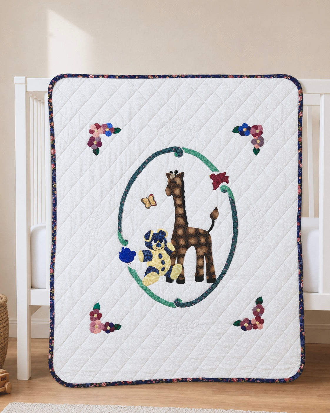 A quilted baby blanket with a giraffe and teddy bear design, draped over a white crib in a nursery setting.